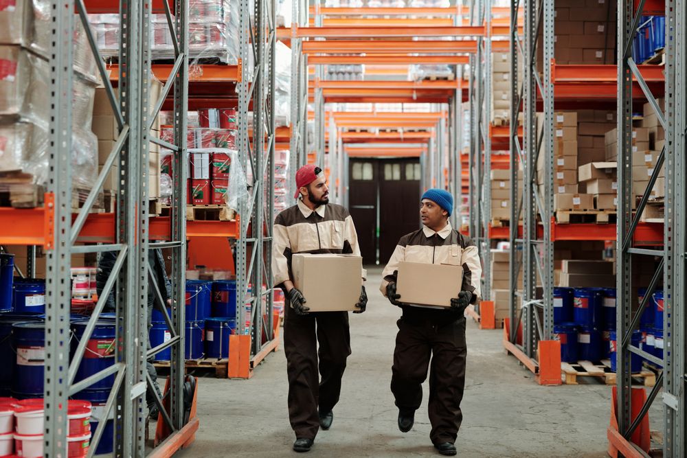 Warehouse workers carrying packages